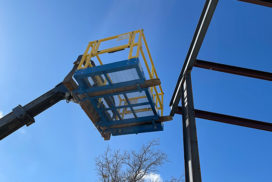 Safety Work Platform lifted to top of construction site