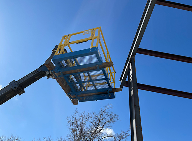 Safety Work Platform lifted to top of construction site