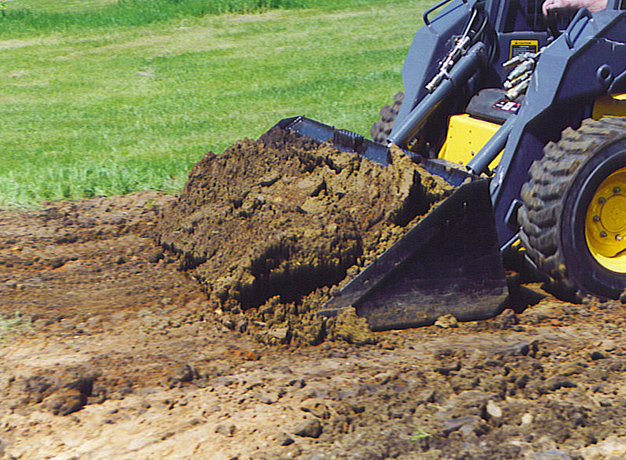 Skid-steer bucket moving dirt